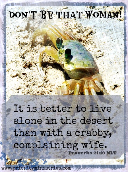 A crab sits on a beach in the sun with Proverbs 21:19 written below.