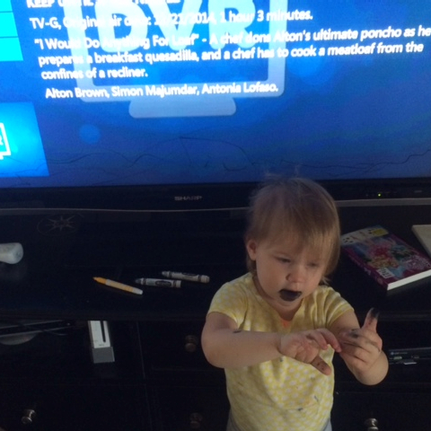 Toddler with black marker on face and on the T.V.